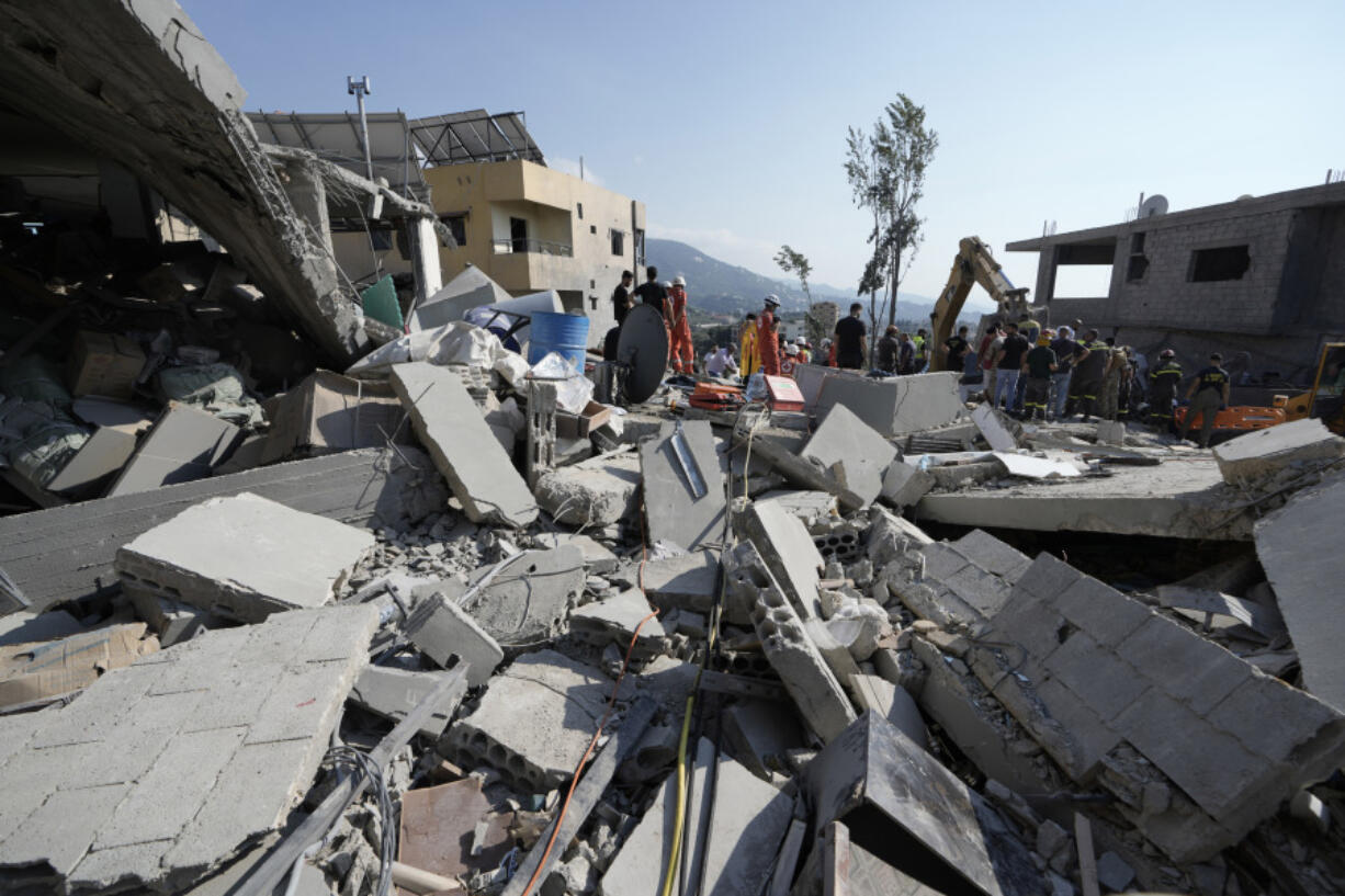 Emergency workers arrive at the scene of an Israeli airstrike Wednesday in Maisara, Lebanon, north of Beirut.