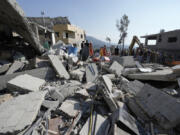 Emergency workers arrive at the scene of an Israeli airstrike Wednesday in Maisara, Lebanon, north of Beirut.