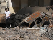 A man walks on rubble at the site of an Israeli airstrike in Beirut&#039;s southern suburbs, Sunday, Sept. 29, 2024.