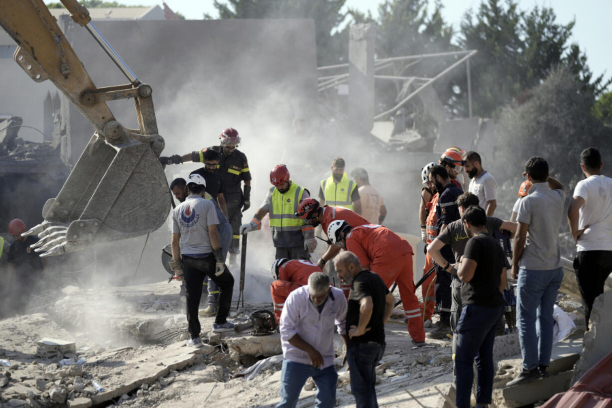 Emergency workers search for survivors at the scene of an Israeli airstrike in the town of Maisara, north of Beirut, Wednesday, Sept. 25, 2024.