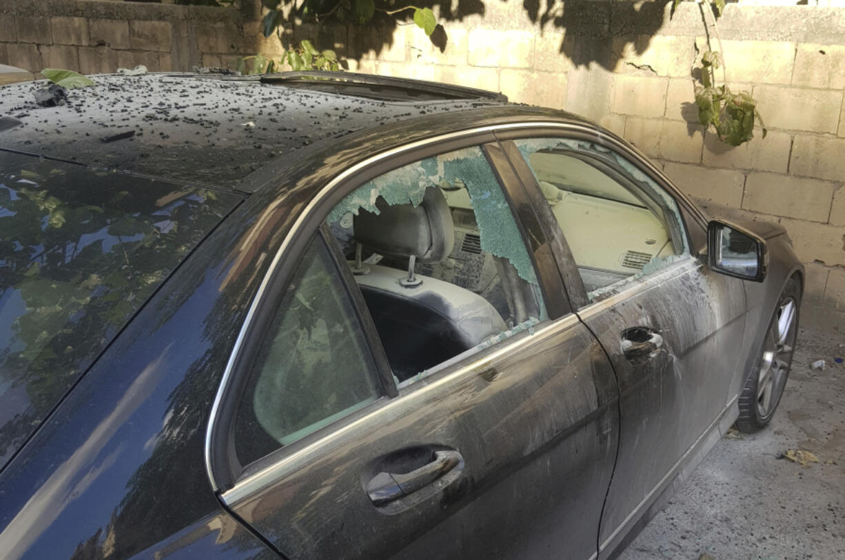 A partly damaged car after what is believed to be the result of a walkie-talkie exploding inside it, in the southern port city of Sidon, Lebanon, Wednesday, Sept. 18, 2024.