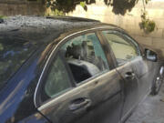 A partly damaged car after what is believed to be the result of a walkie-talkie exploding inside it, in the southern port city of Sidon, Lebanon, Wednesday, Sept. 18, 2024.