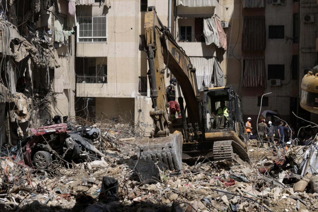 Emergency workers clear the rubble at the site of Friday&#039;s Israeli strike in Beirut&#039;s southern suburb, Sunday, Sept. 22, 2024.