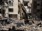 Emergency workers clear the rubble at the site of Friday&#039;s Israeli strike in Beirut&#039;s southern suburb, Sunday, Sept. 22, 2024.