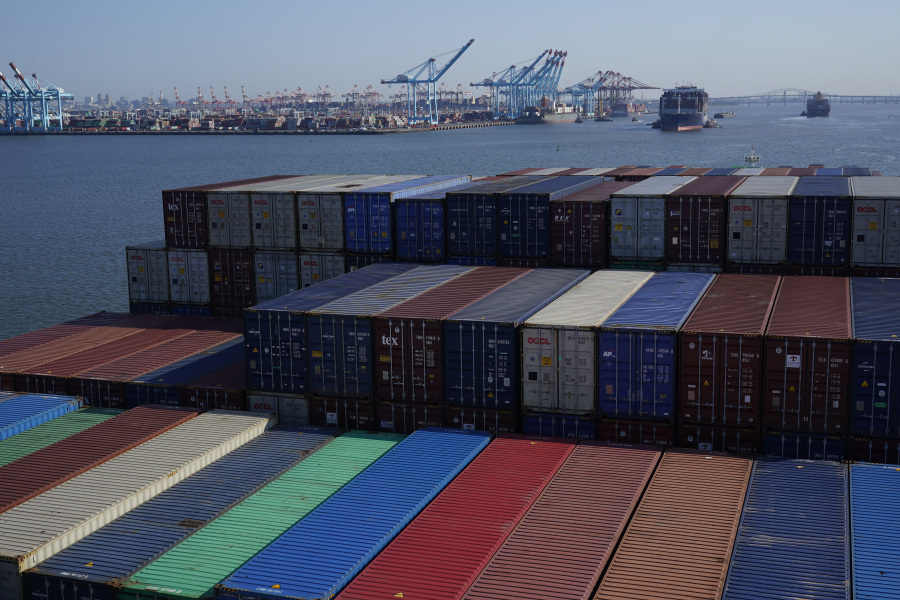 FILE - A container ship makes it way toward the Port of New York and New Jersey in Elizabeth, N.J., on June 30, 2021.