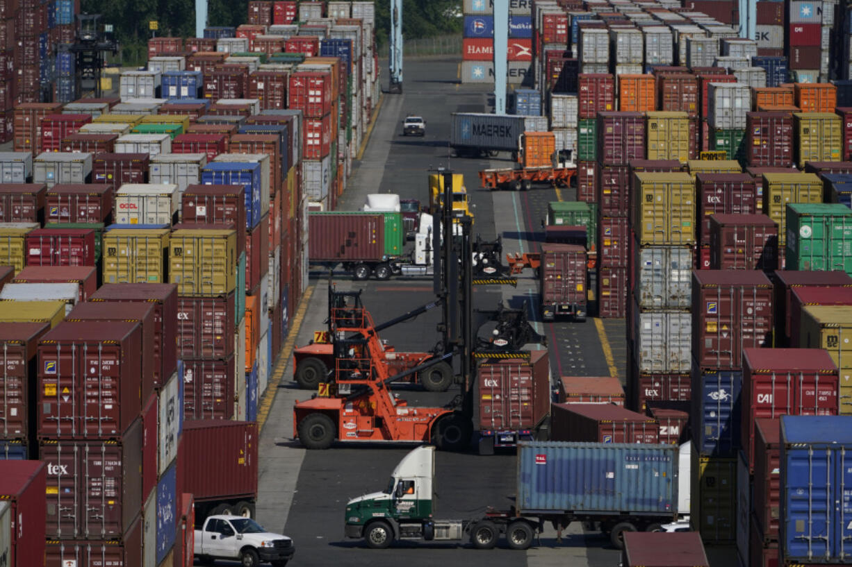 FILE - Containers are moved at the Port of New York and New Jersey in Elizabeth, N.J., on June 30, 2021.