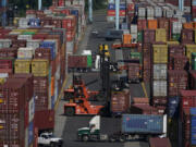 FILE - Containers are moved at the Port of New York and New Jersey in Elizabeth, N.J., on June 30, 2021.