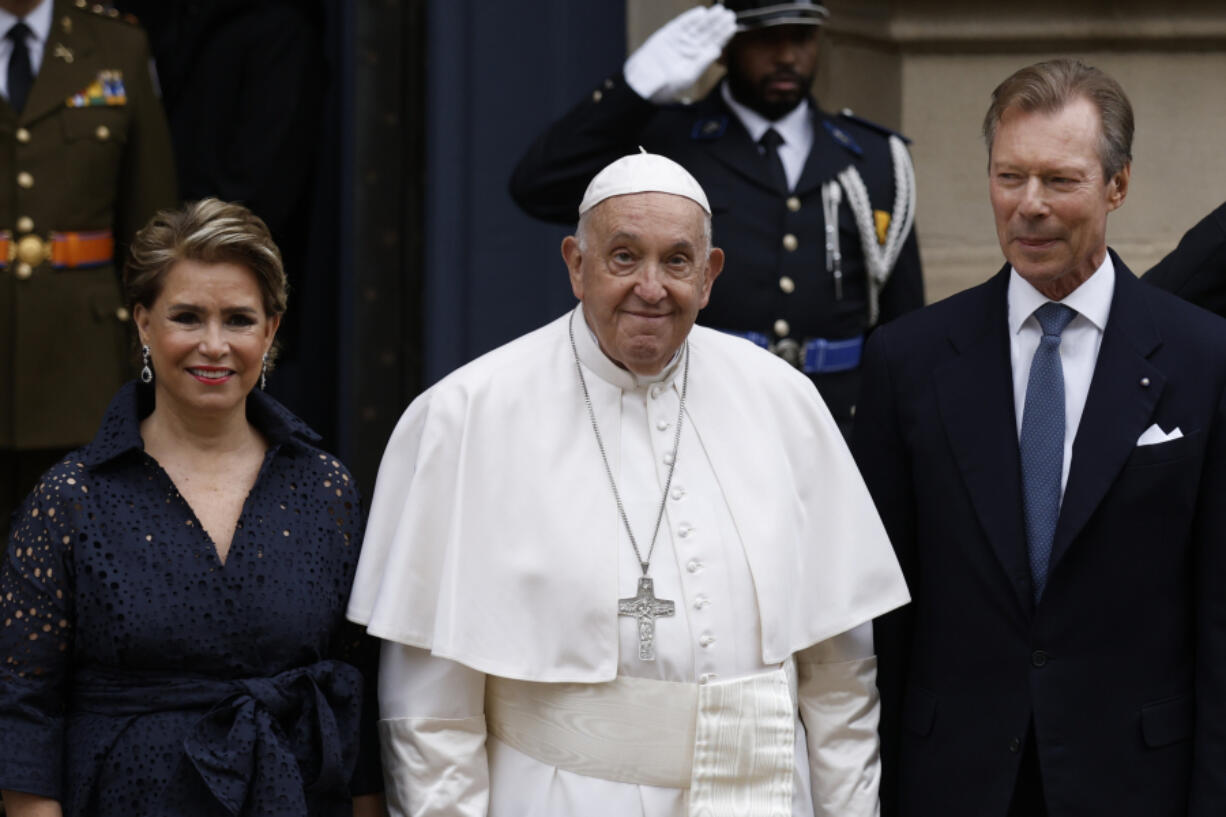 Pope Francis, center, is received by Luxembourg&rsquo;s Grand Duke Henri, right, and Grand Duchess Maria Teresa, left, as he arrives at the Grand Ducal Palace in Luxembourg to start his four-day visit to Luxembourg and Belgium, Thursday, Sept. 26, 2024.