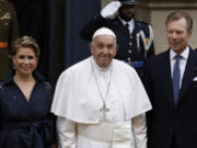 Pope Francis, center, is received by Luxembourg&rsquo;s Grand Duke Henri, right, and Grand Duchess Maria Teresa, left, as he arrives at the Grand Ducal Palace in Luxembourg to start his four-day visit to Luxembourg and Belgium, Thursday, Sept. 26, 2024.