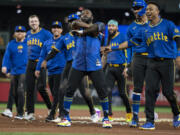 Seattle Mariners' Randy Arozarena, center, celebrates with teammates including Jorge Polanco, far right, and Julio Rodriguez, second from right, after a baseball game against the Texas Rangers, Saturday, Sept. 14, 2024, in Seattle.