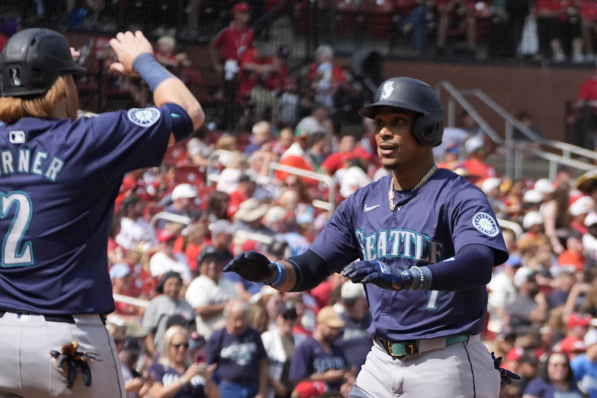 Seattle Mariners&#039; Jorge Polanco, right, is congratulated by teammate Justin Turner (2) after hitting a two-run home run during the fifth inning of a baseball game against the St. Louis Cardinals Sunday, Sept. 8, 2024, in St. Louis.