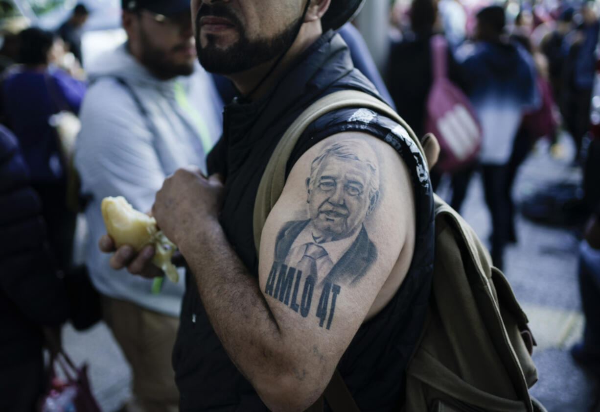 FILE - A supporter of Mexican President Andres Manuel Lopez Obrador sporting a tattoo of the president arrives for a march to show support for Lopez Obrador&rsquo;s administration in Mexico City, Nov. 27, 2022.