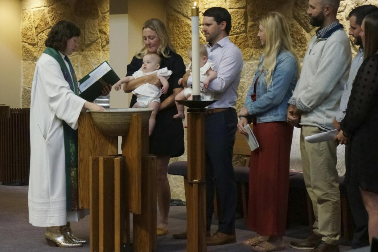 The Rev. Elise Pokel performs baptisms at Transfiguration Lutheran Church in Bloomington, Minn, on Sept. 8, 2024.