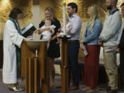 The Rev. Elise Pokel performs baptisms at Transfiguration Lutheran Church in Bloomington, Minn, on Sept. 8, 2024.