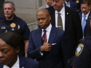 New York City mayor Eric Adams, center, departs Manhattan federal court after an appearance, Friday, Sept. 27, 2024, in New York.