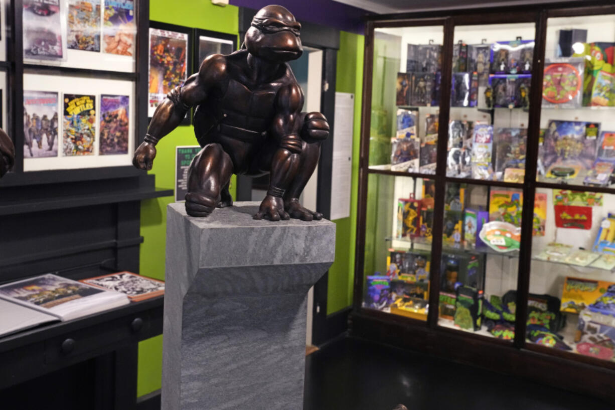 A bronze sculpture of the Teenage Mutant Ninja Turtle character Raphael is displayed Sept. 5 along with comic books and memorabilia in a permanent collection at the Woodman Museum in Dover, N.H.