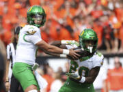 Oregon quarterback Dillon Gabriel (8) hands off the ball to running back Jordan James (20) during the first half of an NCAA football game, Saturday, Sept. 14, 2024, in Corvallis, Ore.