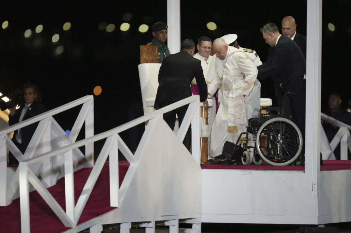 Pope Francis is helped down a ramp at Jackson&rsquo;s International Airport in Port Moresby, Papua New Guinea, Friday, Sept. 6, 2024.