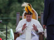 Pope Francis receives a traditional hat during a meeting with faithful in Vanimo, Papua New Guinea, Sunday, Sept. 8, 2024.