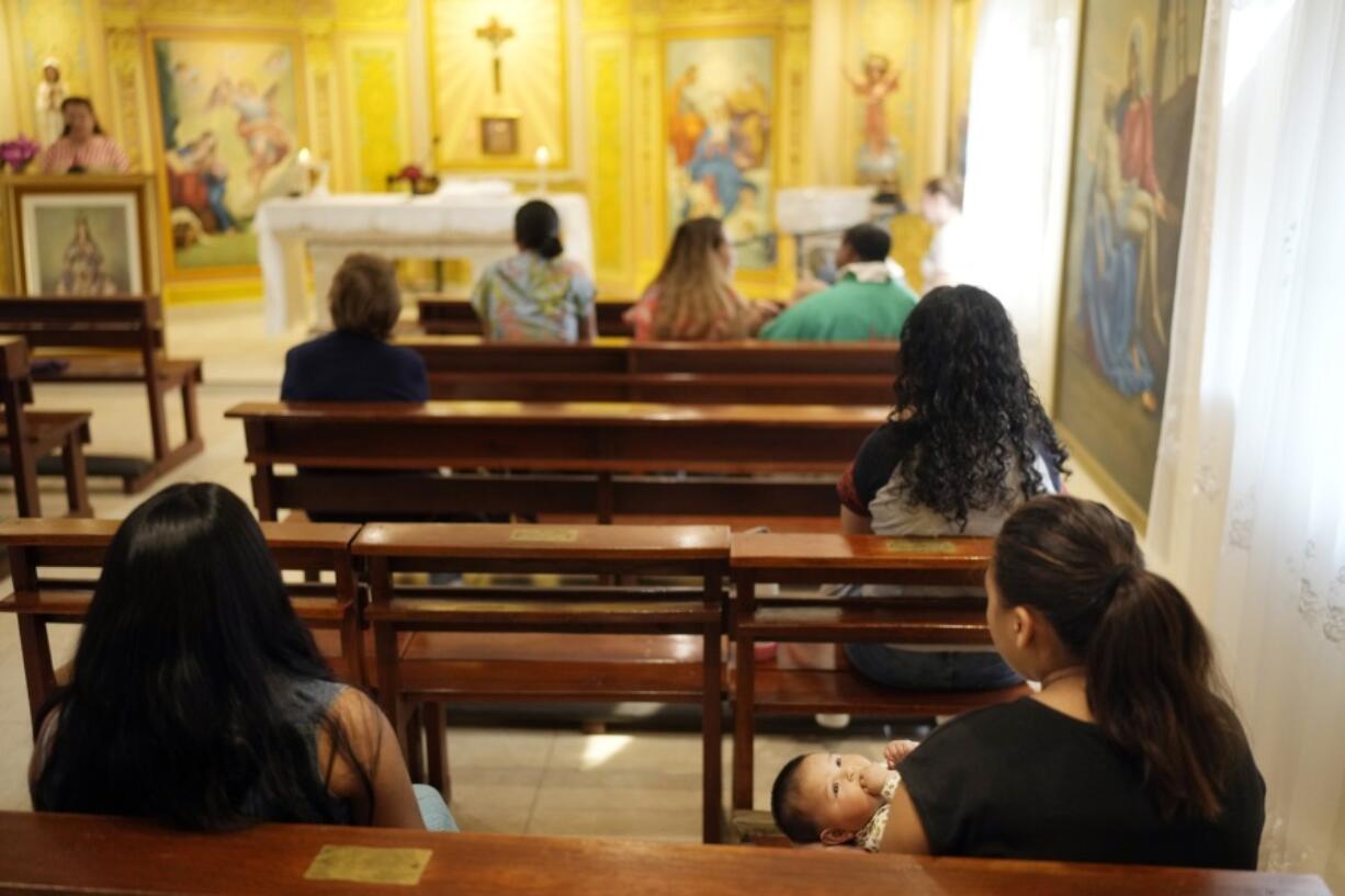 People attend Mass at the Catholic shelter for young mothers, Casa Rosa Maria, in Asuncion, Paraguay, Monday, Aug. 19, 2024. Abortion is punishable by prison time with no exemptions in Paraguay, which has the highest rate of teenage pregnancy in South America.