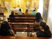 People attend Mass at the Catholic shelter for young mothers, Casa Rosa Maria, in Asuncion, Paraguay, Monday, Aug. 19, 2024. Abortion is punishable by prison time with no exemptions in Paraguay, which has the highest rate of teenage pregnancy in South America.