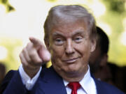 Republican presidential nominee former President Donald Trump motions while attending the 9/11 Memorial ceremony on the 23rd anniversary of the Sept. 11, 2001 terror attacks, Wednesday, Sept. 11, 2024, in New York.