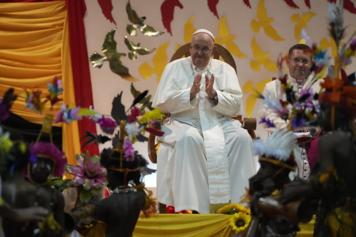 Pope Francis, left, attends a traditional dance performed by the Caritas Technical Secondary School pupils in Port Moresby, Saturday, Sept. 7, 2024.