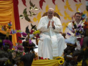 Pope Francis, left, attends a traditional dance performed by the Caritas Technical Secondary School pupils in Port Moresby, Saturday, Sept. 7, 2024.