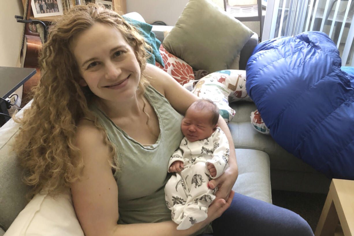 Liz Chrastil, a neuroscientist with the University of California, Irvine, holds her newborn son in May 2020.