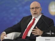 In this handout photo provided by Photo host Agency RIA Novosti, Dimitri Simes, a Russian-American author, editor, and political pundit asks a question to Russian President Vladimir Putin during a plenary session of the St. Petersburg International Economic Forum in St. Petersburg, Russia, June 16, 2023.