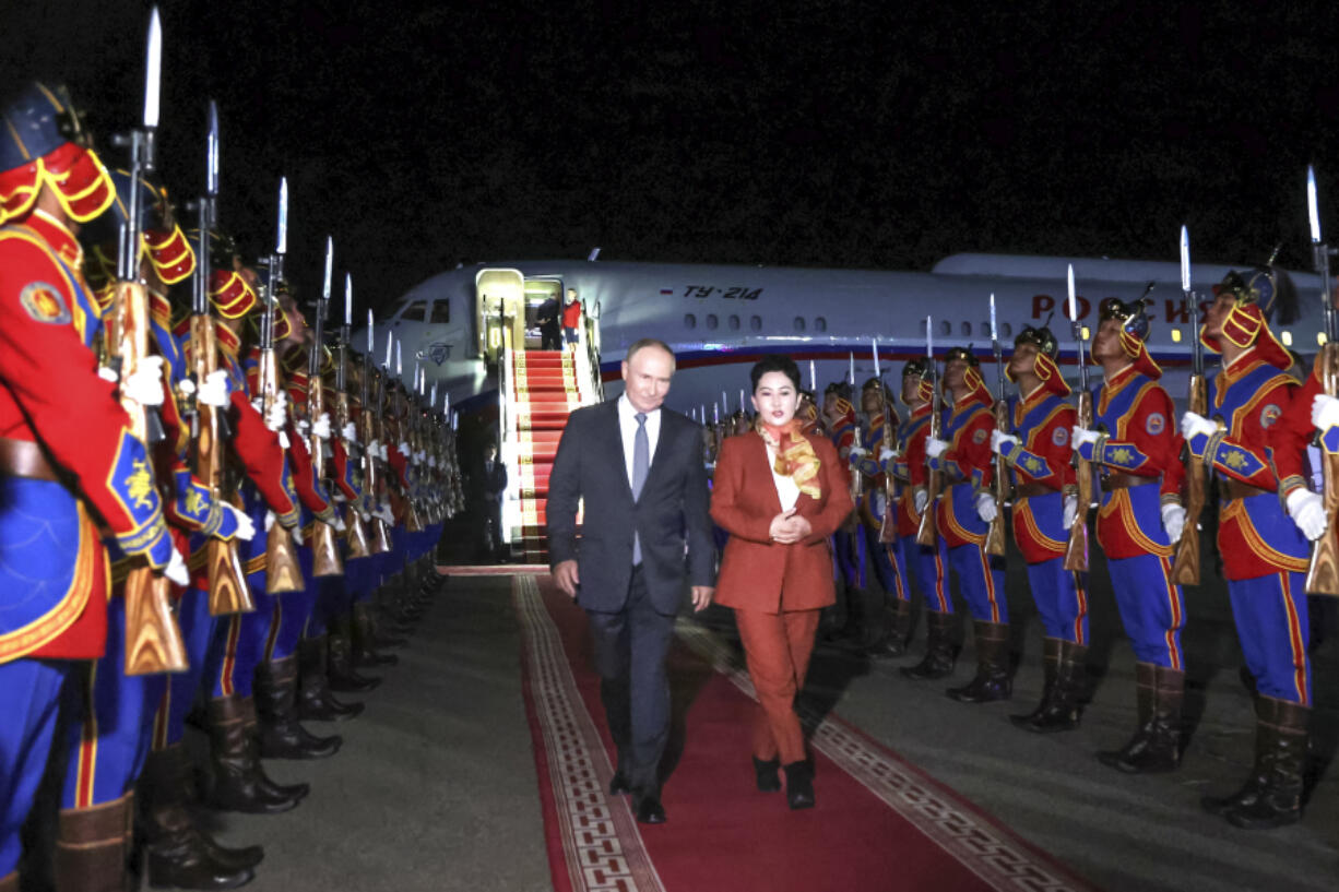 Russian President Vladimir Putin, on red carpet left, walks next to Mongolian Foreign Minister of Mongolia, Batmunkh Battsetseg upon his arrival at Ulaanbaatar&#039;s International airport Chinggis Khaan, late Monday, Sept. 2, 2024.