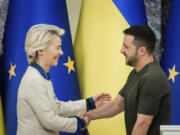 Ursula von der Leyen, left, President of the European Commission, shakes hands with Ukrainian President Volodymyr Zelenskyy, following a joint press conference in Kyiv, Ukraine, Friday, Sept. 20, 2024.