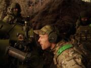 A Ukrainian serviceman of Liut brigade aims his D-30 artillery cannon during firing towards Russian positions near Toretsk, Donetsk region, Ukraine, Sunday Sept. 22, 2024.