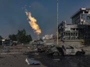 Gas burns in front of a business center damaged by a Russian attack in Kharkiv, Ukraine, Sunday, Sept. 1 2024.