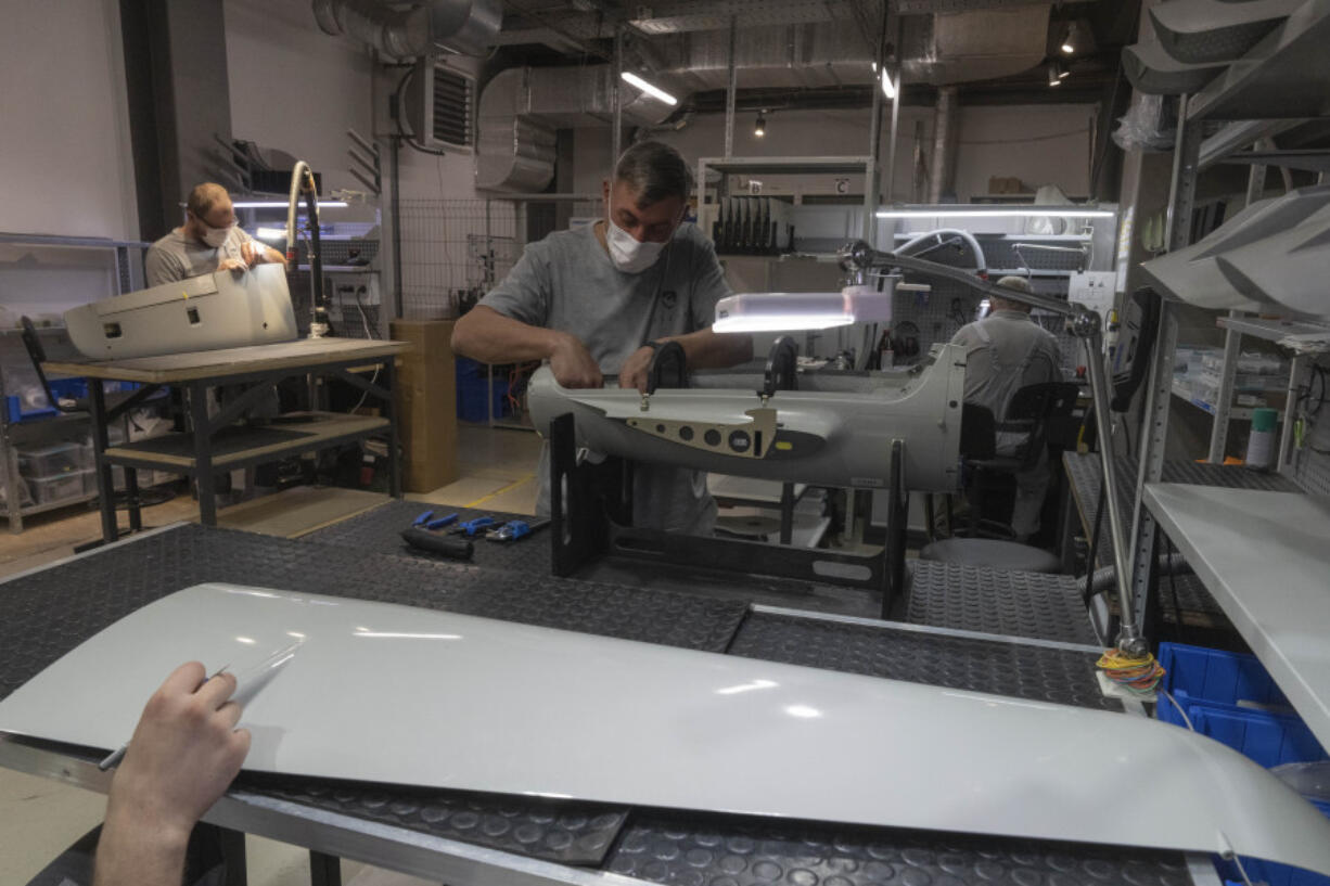 Workers assemble Raybird long-range surveillance drones at the Skyeton drone-manufacturing hub in the Kyiv region, Ukraine, Wednesday, Sept. 25, 2024.