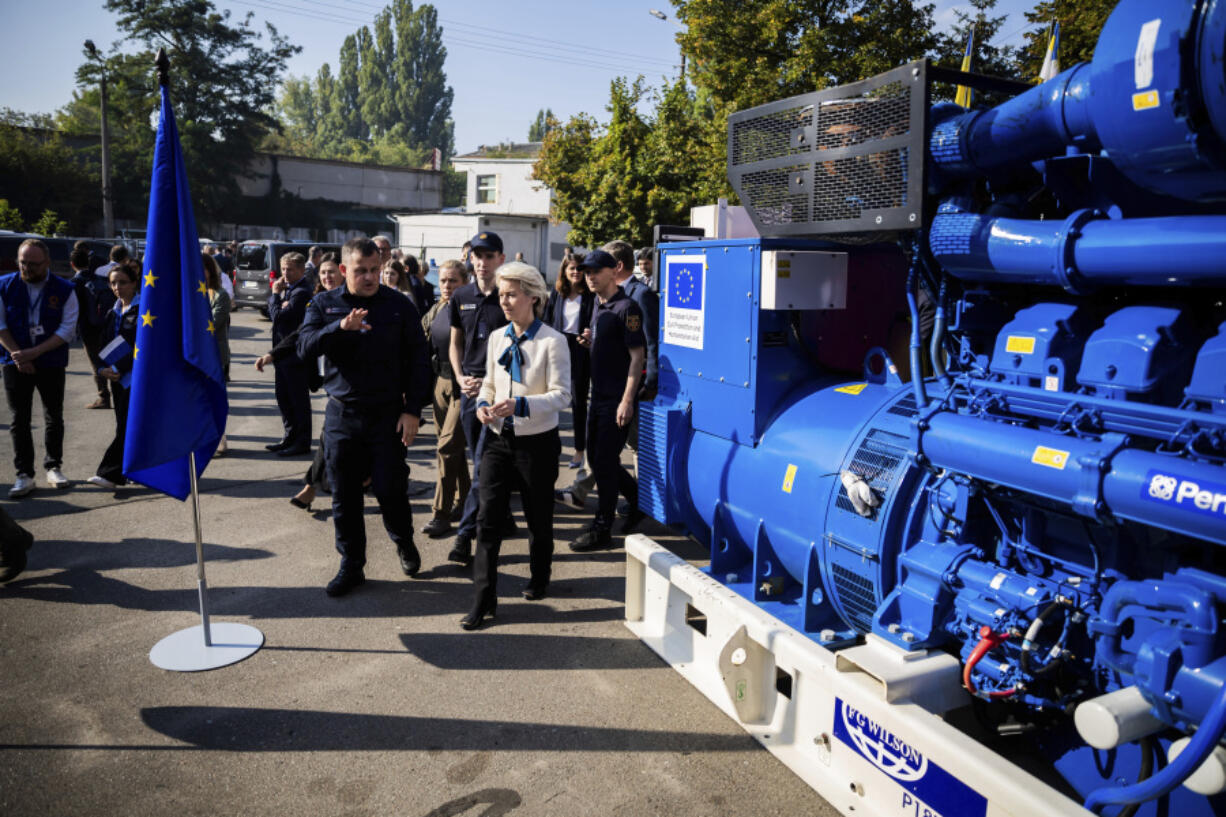 European Commission President Ursula von der Leyen, center, inspects a generator with head of State Emergency Service of Ukraine (SESU)Andriy Danyk during a visit to the headquarters of the State Emergency Service (SESU), in Kyiv, Ukraine, Friday, Sept. 20, 2024.