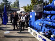 European Commission President Ursula von der Leyen, center, inspects a generator with head of State Emergency Service of Ukraine (SESU)Andriy Danyk during a visit to the headquarters of the State Emergency Service (SESU), in Kyiv, Ukraine, Friday, Sept. 20, 2024.