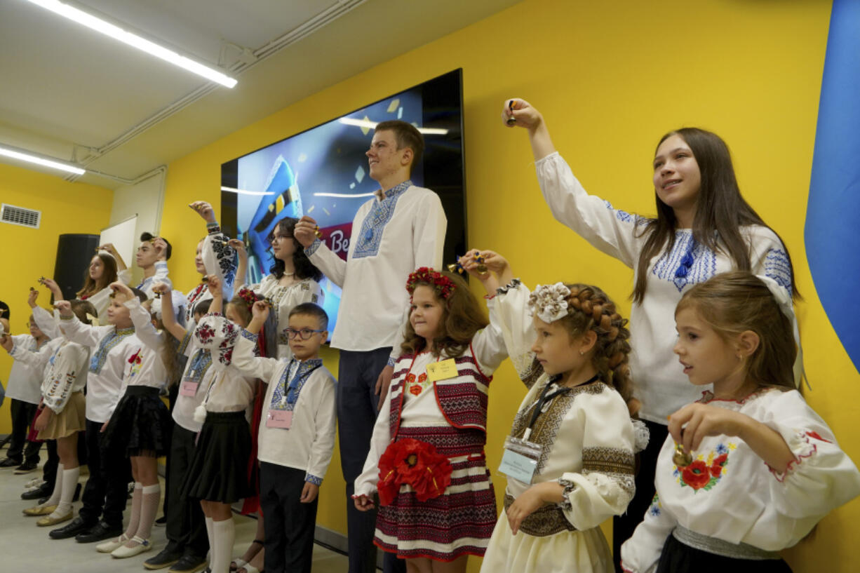 Schoolchildren ring the bells on the first day at school in an underground school in Kharkiv, Ukraine, Monday, Sept. 2, 2024. The purpose-built &quot;bunker school&quot; aims to provide a learning environment safe from Russian everyday airstrikes.