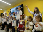 Schoolchildren ring the bells on the first day at school in an underground school in Kharkiv, Ukraine, Monday, Sept. 2, 2024. The purpose-built &quot;bunker school&quot; aims to provide a learning environment safe from Russian everyday airstrikes.