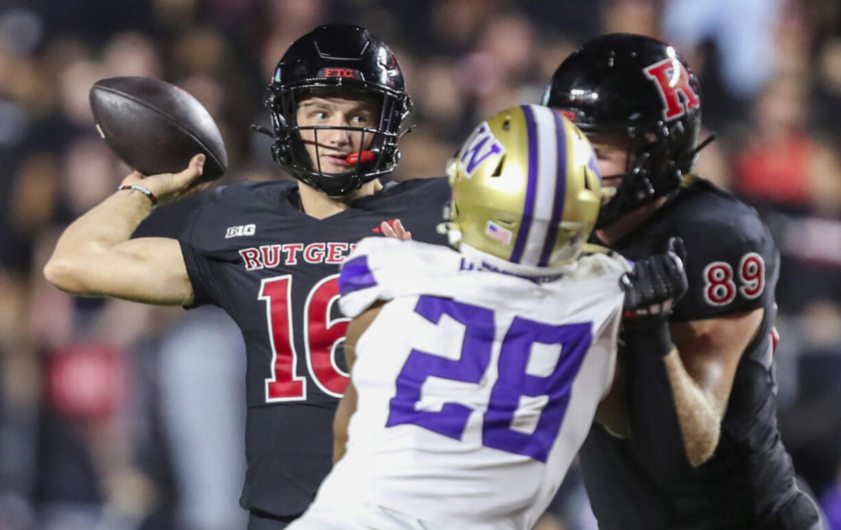 Rutgers quarterback Athan Kaliakmanis (16) throws a pass during the first half of an NCAA football game against Washington, Friday, Sept. 27 2024, in Piscataway, N.J.