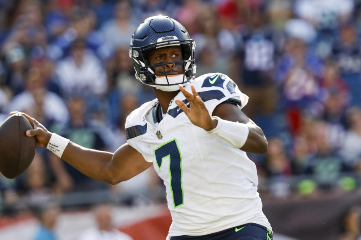 Seattle Seahawks quarterback Geno Smith (7) prepares to make a pass during overtime of an NFL football game against the New England Patriots on Sunday, Sept. 15, 2024, in Foxborough, Mass. The Seattle Seahawks defeated the New England Patriots 23-20. (AP Photo/Greg M.