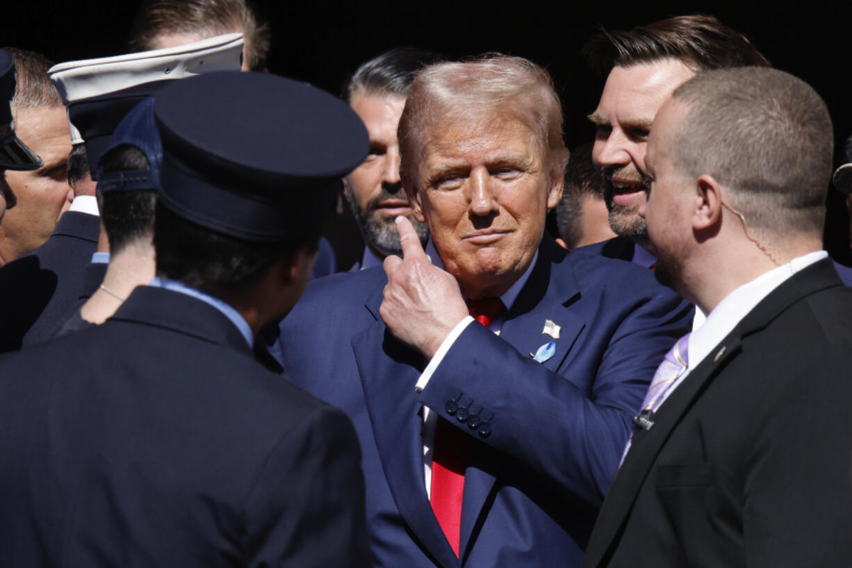 Republican presidential nominee former President Donald Trump, center, and Republican vice presidential nominee Sen. JD Vance, R-Ohio, second from right, visit the firehouse of Engine 4 Ladder 15 on the 23rd anniversary of the Sept. 11, 2001 terror attacks, Wednesday, Sept. 11, 2024, in New York.