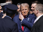 Republican presidential nominee former President Donald Trump, center, and Republican vice presidential nominee Sen. JD Vance, R-Ohio, second from right, visit the firehouse of Engine 4 Ladder 15 on the 23rd anniversary of the Sept. 11, 2001 terror attacks, Wednesday, Sept. 11, 2024, in New York.