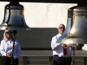 The Bells of Remembrance are rung by Fred Lukachinsky, president of Friends of Flight 93, and Donna Gibson, left, executive director of Friends of Flight 93, at the Flight 93 National Memorial on the 23rd anniversary of the Sept. 11 attacks in Shanksville, Pa., Wednesday, Sept. 11, 2024.