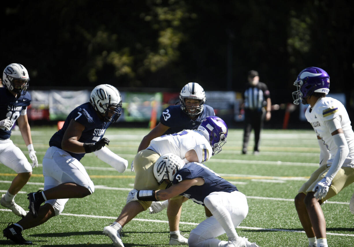 Skyview's Rex Allinger (0) tackles Puyallup's Kyson Douglas (2) during a non-league football game on Saturday, Sept. 21, 2024, at Kiggins Bowl.