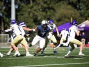 Skyview's Riah Tua (7) breaks through Puyallup's offensive line to sack quarterback Brayden Paulino (11) during a non-league football game on Saturday, Sept. 21, 2024, at Kiggins Bowl.