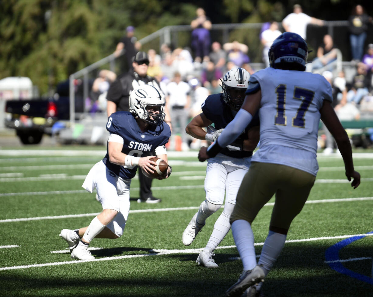 Skyview's Gavin Packer (8) looks to run after faking a handoff during a non-league football game against Puyallup on Saturday, Sept. 21, 2024, at Kiggins Bowl.