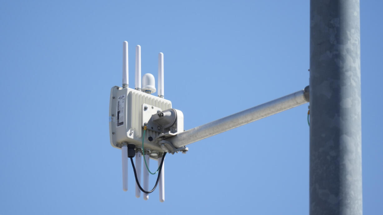 A radio transmitter hangs from a traffic light pole as it transmits to equipped commuter buses on Redwood Road, part of an effort to improve safety and efficiency by allowing cars to communicate with the roadside infrastructure and one another, near Salt Lake City.