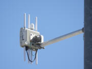 A radio transmitter hangs from a traffic light pole as it transmits to equipped commuter buses on Redwood Road, part of an effort to improve safety and efficiency by allowing cars to communicate with the roadside infrastructure and one another, near Salt Lake City.