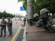 South Korean army soldiers aim their machine guns as they control traffic during a civil defense drill as a part of the Ulchi Freedom Shield military exercise between the U.S. and South Korea in Seoul, South Korea, Thursday, Aug. 22, 2024.